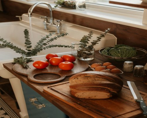 Fresh bread and vegetables on a wooden cutting board